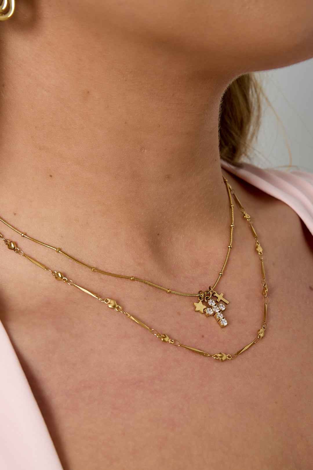Necklace with cross and star charms