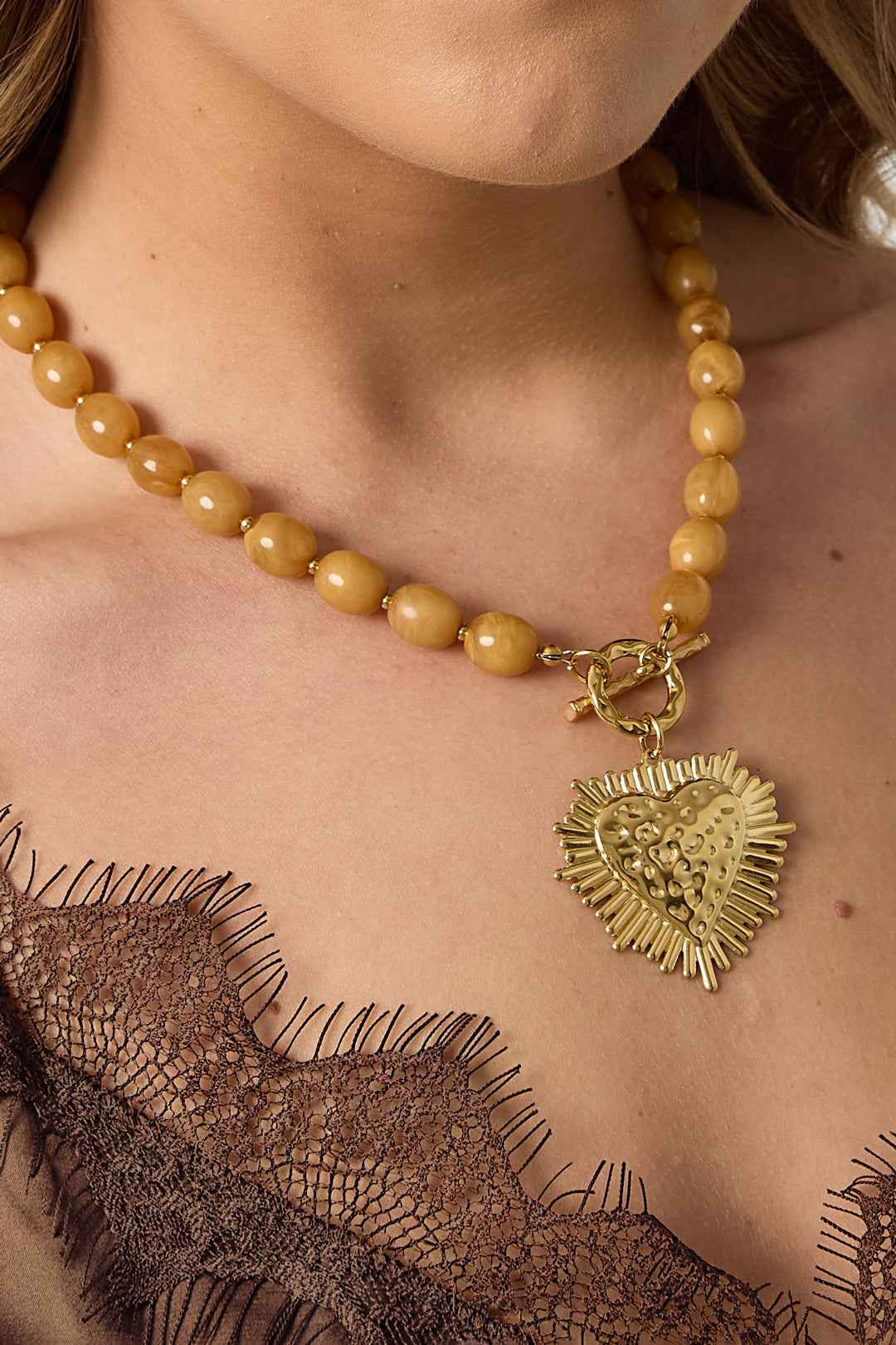 Bead necklace with front closure charm
