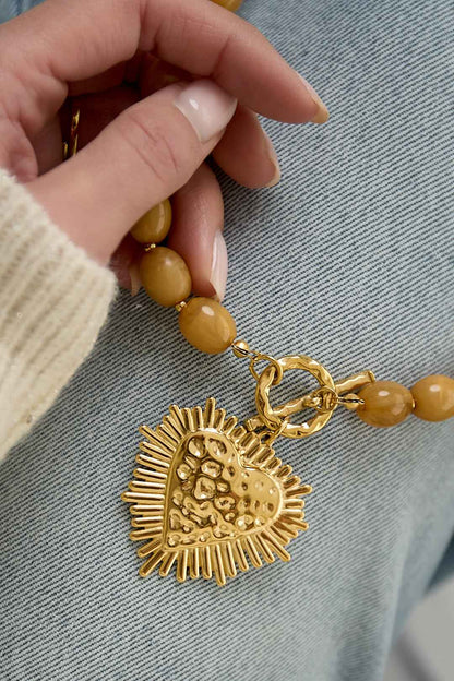 Bead necklace with front closure charm