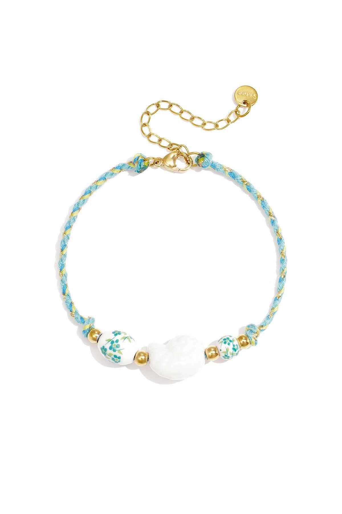 Armband van touw met schelp en kralen met bloemdesign