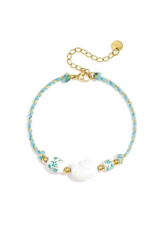 Armband van touw met schelp en kralen met bloemdesign