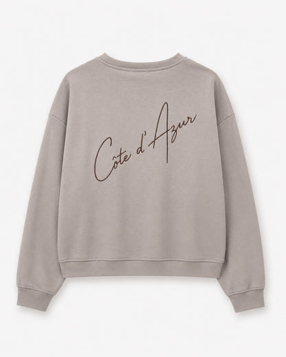 MOOIJ Sweater Celine Côte d'Azur beige achterkant met grote geborduurde tekst